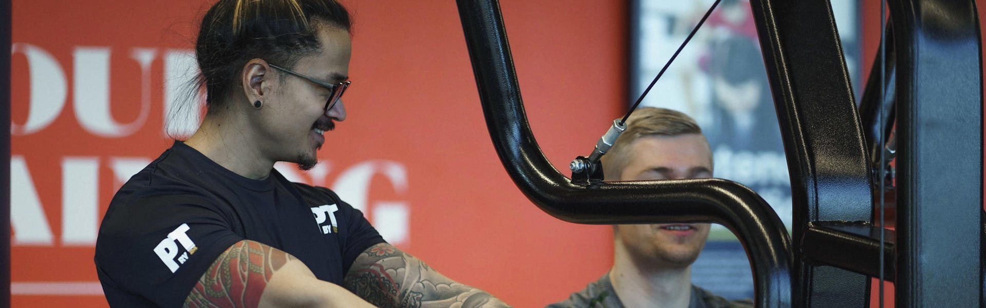 Personal trainer assisting row