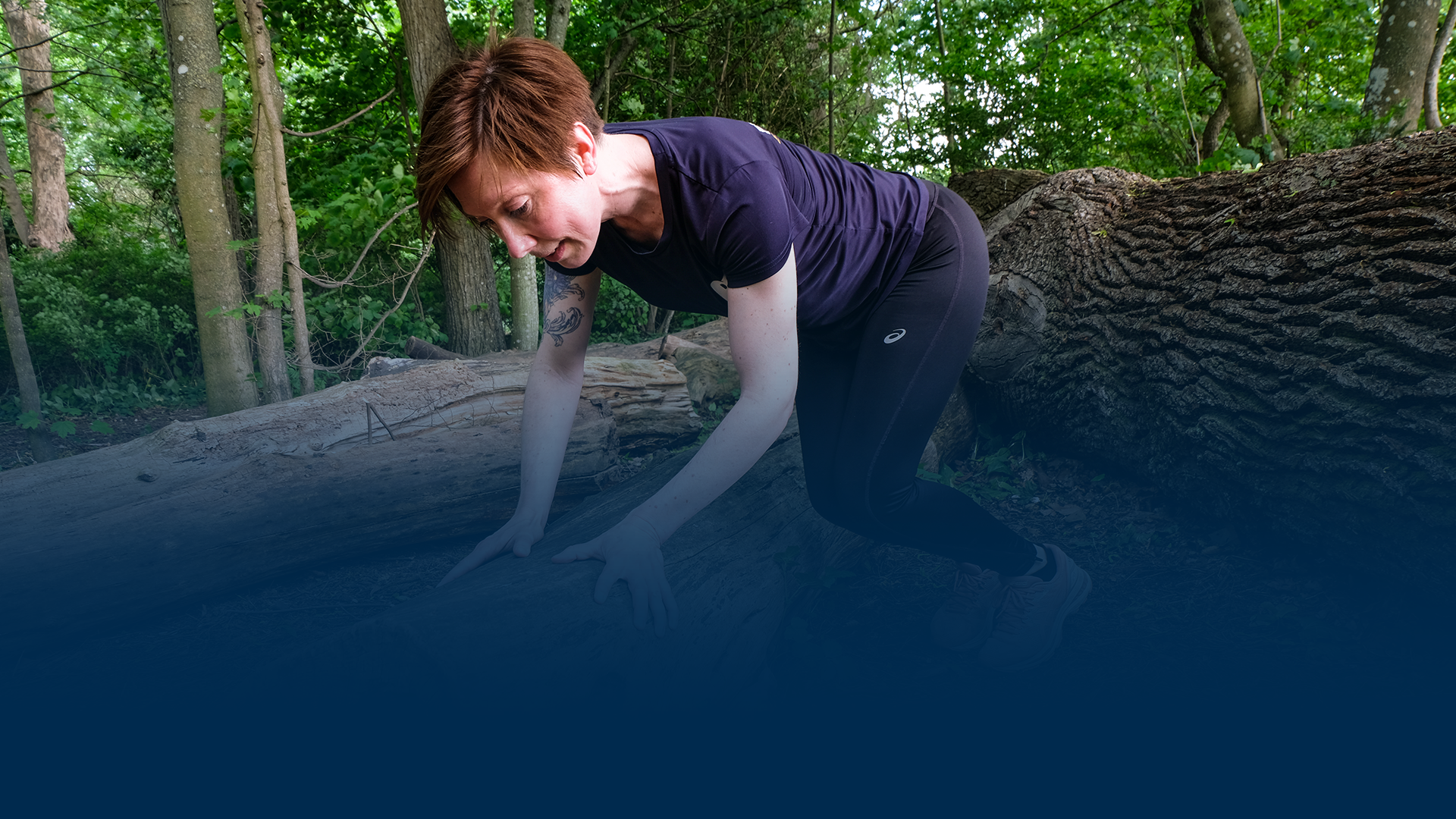 Woman jumping over wood.