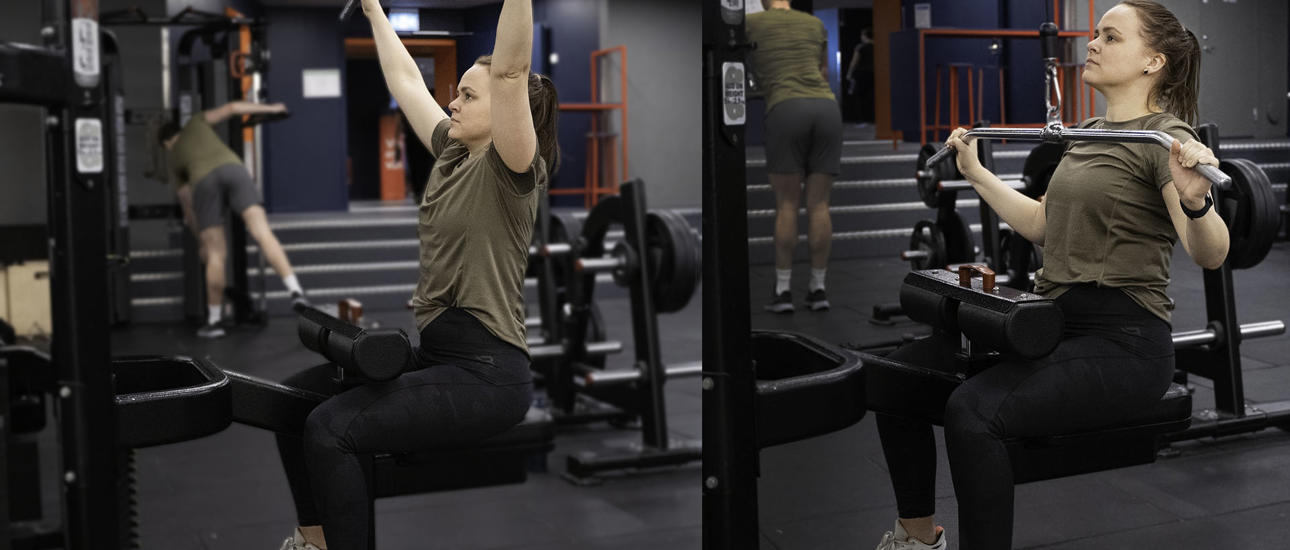 Kvinna kör latsdrag på gymmet
